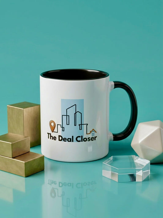 White mug with black handle featuring 'The Deal Closer' logo on a teal background